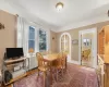 Dining area with wood-type flooring, radiator heating unit, and a healthy amount of sunlight