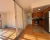 Kitchen with baseboard heating, light wood-type flooring, and appliances with stainless steel finishes