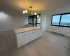 Kitchen featuring decorative light fixtures, white cabinetry, and light hardwood / wood-style floors