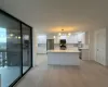 Kitchen featuring white cabinets, sink, hanging light fixtures, light wood-type flooring, and stainless steel appliances