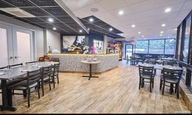 Dining area featuring a wall of windows and light wood-type flooring