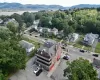 Aerial view featuring the subject property and the parking area with the view of the Hudson River and Mount Beacon in the background.