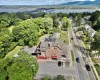 Aerial view featuring the subject property the exterior store entrance the parking lot plus a water view of the Hudson River...