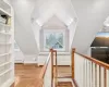 Unfurnished bedroom with a closet, light wood-type flooring, and vaulted ceiling