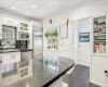 Kitchen featuring backsplash, white cabinets, sink, built in appliances, and kitchen peninsula