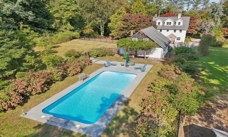 View of pool with a lawn and a patio