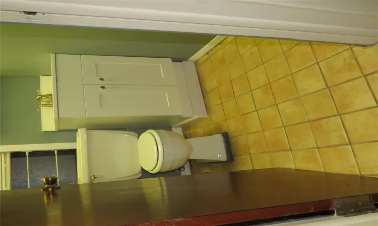 Bathroom with toilet, vanity, and tile patterned floors