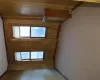 Spare room with light carpet and wood walls