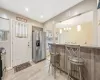 Kitchen featuring a healthy amount of sunlight, a kitchen bar, light wood-type flooring, and stainless steel appliances