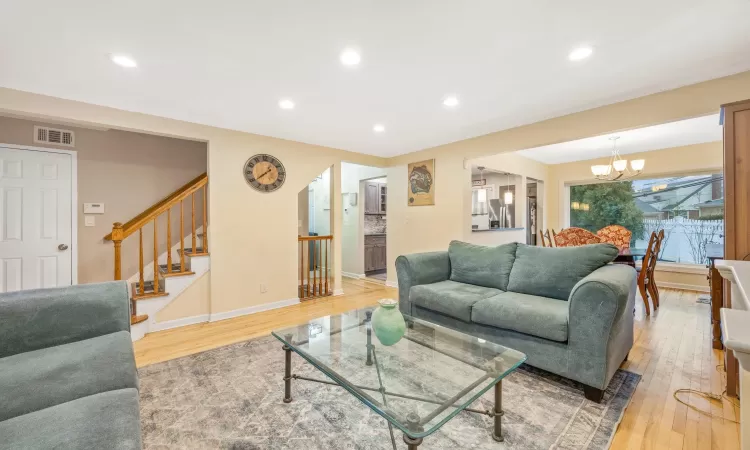 Living room featuring a chandelier and wood-type flooring