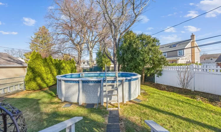 View of yard with a fenced in pool