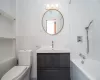 Full bathroom with vanity, toilet, and tiled shower / bath