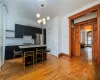 Kitchen featuring a breakfast bar, hanging light fixtures, an island with sink, and appliances with stainless steel finishes