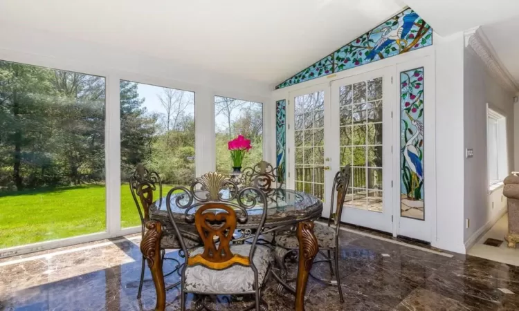 Sunroom featuring french doors and vaulted ceiling