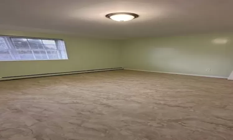 Spare room with a baseboard heating unit