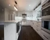 Empty room with crown molding, plenty of natural light, and dark wood-type flooring