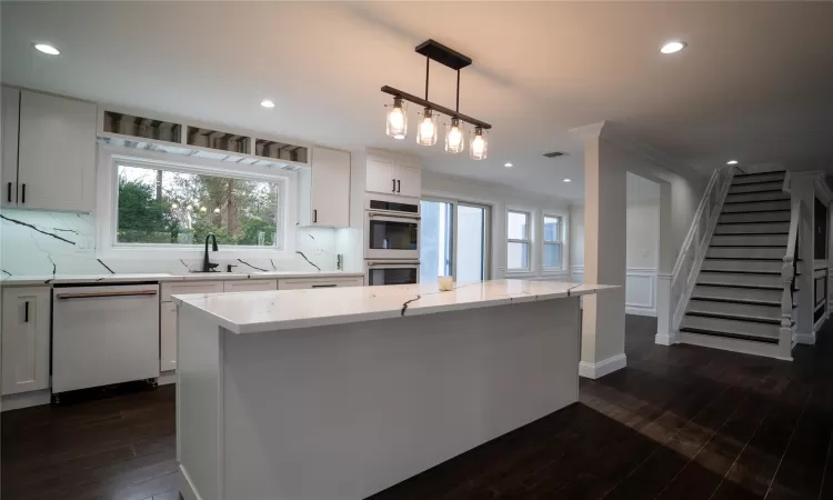 Master Bedroom featuring a wealth of natural light, dark wood-type flooring, and a notable chandelier