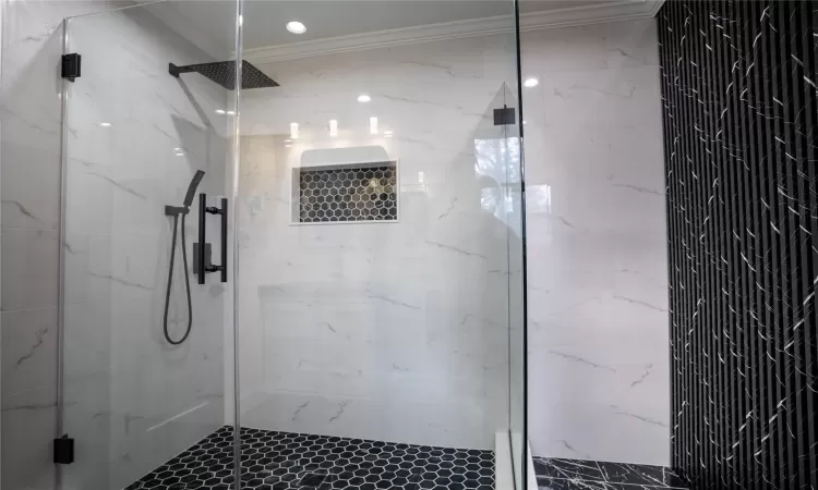 Bathroom with crown molding, toilet, and tile walls