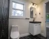 Bathroom featuring toilet, a shower with shower door, ornamental molding, and tile walls