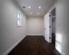 Empty room with dark hardwood / wood-style flooring