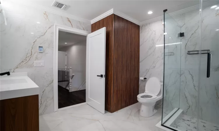 Bathroom featuring an enclosed shower and crown molding