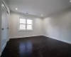 Bathroom featuring a shower, toilet, tile walls, and crown molding