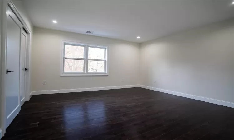 Bathroom featuring a shower, toilet, tile walls, and crown molding