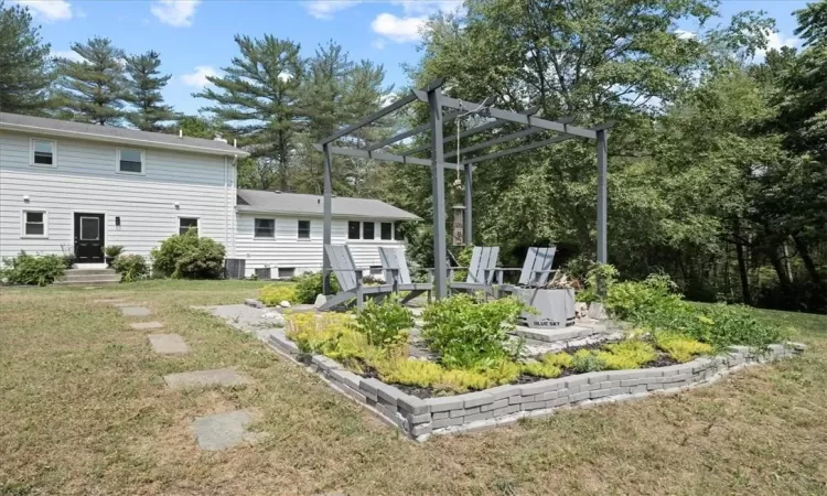 View of yard featuring a pergola, a patio, and central air condition unit