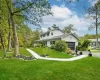 View of front of house featuring a garage and a front lawn