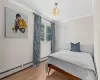 Bedroom featuring hardwood / wood-style flooring and crown molding