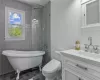 Bathroom featuring tile floors, vanity, toilet, and tile walls