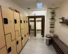 Hallway featuring a skylight and light hardwood / wood-style flooring