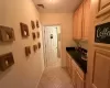 Kitchen with sink, light tile patterned flooring, and light brown cabinets