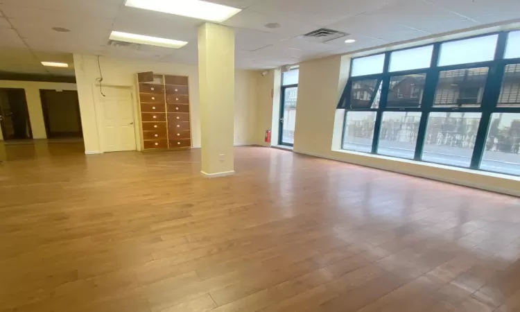 Spare room featuring hardwood / wood-style flooring and a drop ceiling