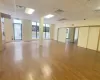 Empty room featuring a drop ceiling and hardwood / wood-style floors