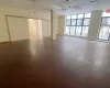 Empty room with a paneled ceiling and a wealth of natural light