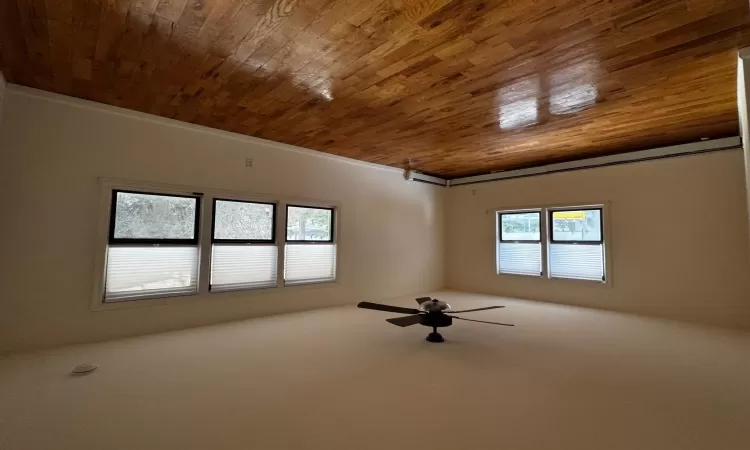 Spare room with hardwood / wood-style floors, ceiling fan, and a baseboard heating unit