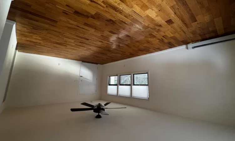 Empty room with ceiling fan, a baseboard radiator, and hardwood / wood-style flooring