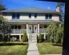 View of front facade with a front yard and a porch