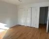 Unfurnished bedroom featuring multiple closets and light wood-type flooring