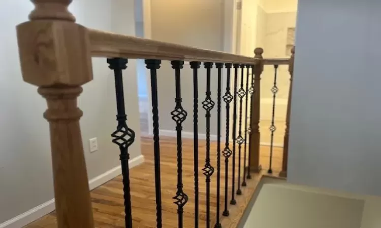 Staircase with hardwood / wood-style floors