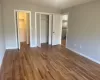 Unfurnished bedroom featuring dark hardwood / wood-style floors and a closet