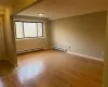 Spare room with light hardwood / wood-style floors and a baseboard heating unit