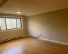 Living Room/Dining Rm Combination with light wood-type flooring and baseboard heating