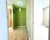 Corridor featuring light hardwood / wood-style flooring and a baseboard radiator