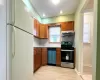 Kitchen featuring decorative backsplash, light hardwood / wood-style flooring, and stainless steel appliances