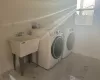 Clothes washing area with washer and clothes dryer