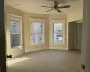 Empty room with carpet and ceiling fan