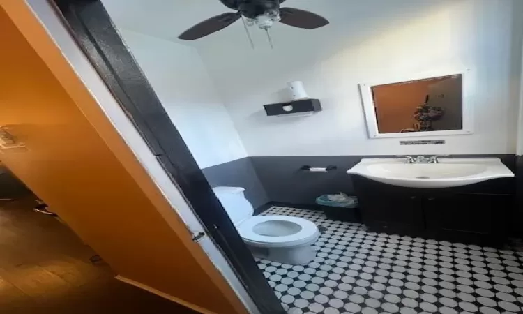 Bathroom featuring ceiling fan, vanity, and toilet