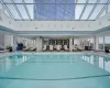 View of pool featuring a skylight